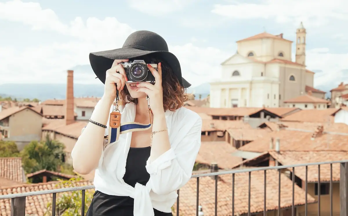 Photographer, tourist, snapshot — illustrating How to Convert HEIC to JPG Online (2026)