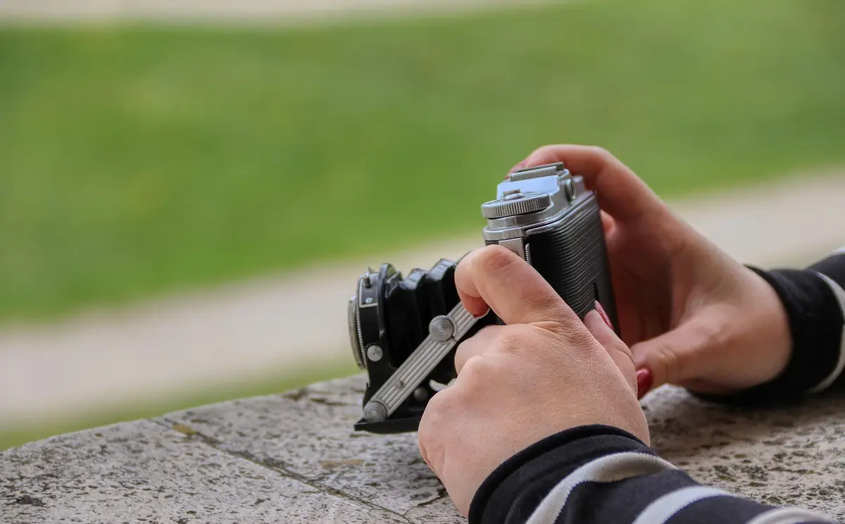 Photography, hand, taking photos — illustrating How to Convert WebP to JPG Online (2026)